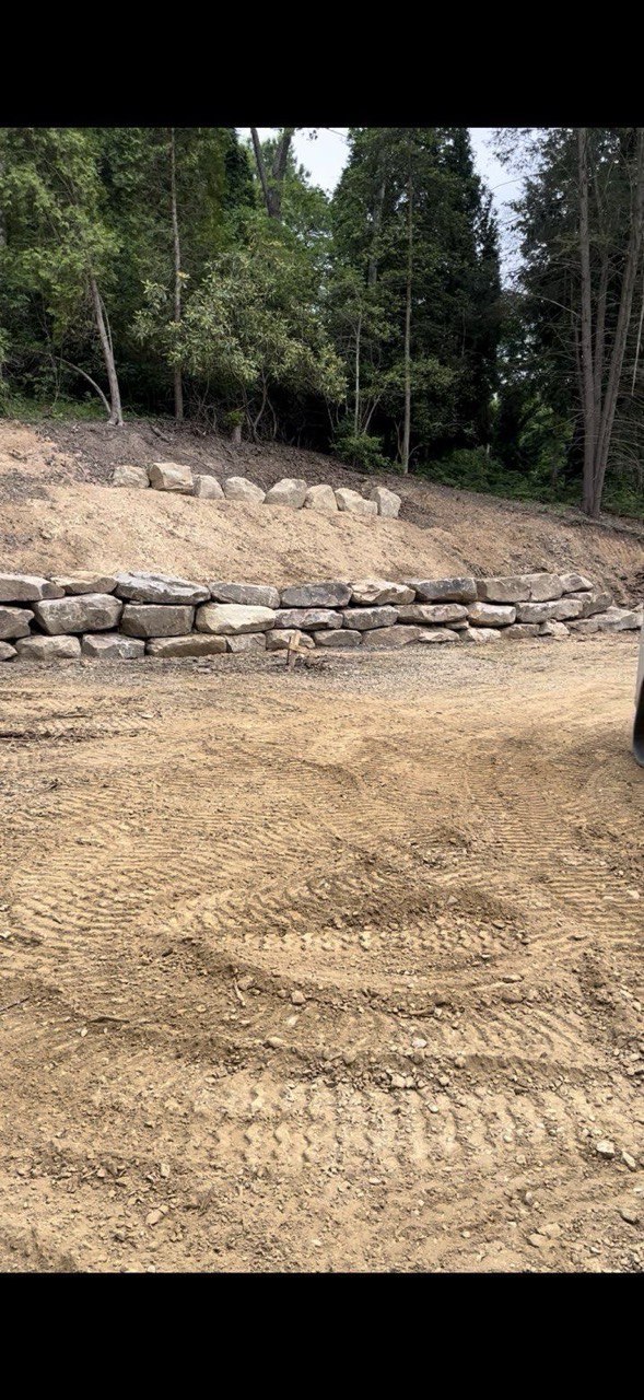Boulder retaining wall site prep